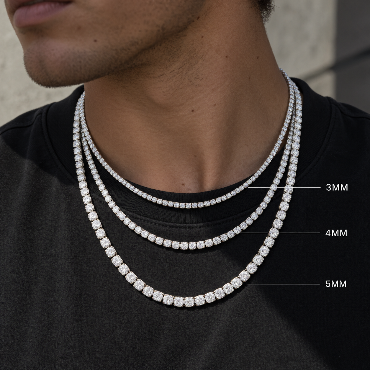 Three cubic zirconia tennis necklaces layered on a neck, labelled 3 mm, 4 mm and 5 mm for size comparison
